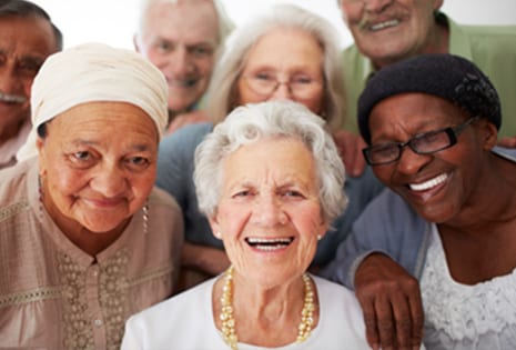 A group of elderly individuals smiling for a picture